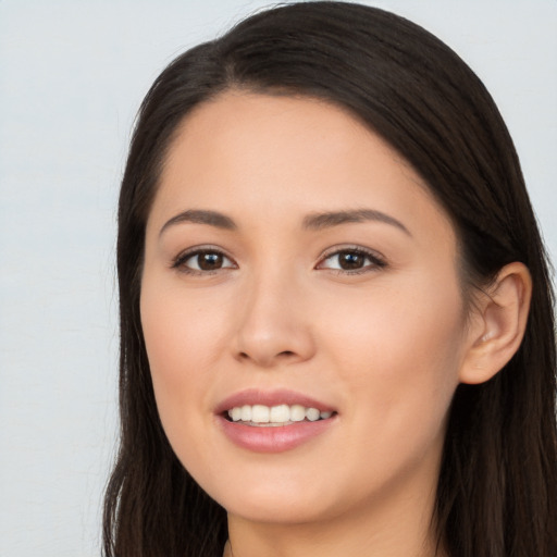 Joyful asian young-adult female with long  brown hair and brown eyes