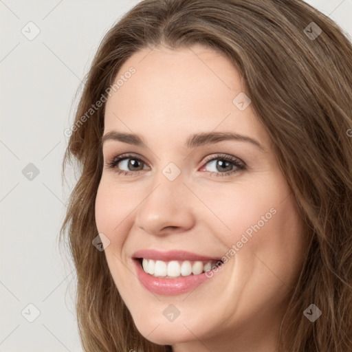 Joyful white young-adult female with long  brown hair and green eyes