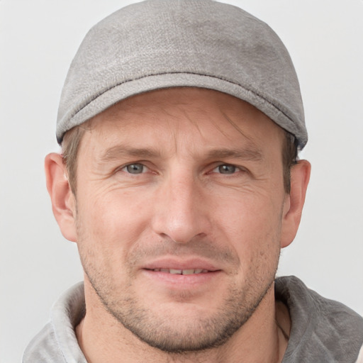 Joyful white adult male with short  brown hair and grey eyes