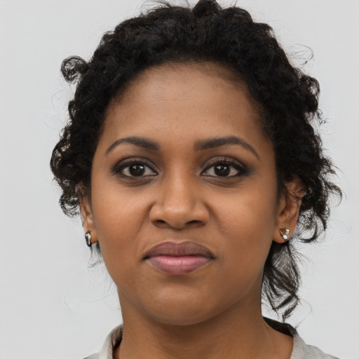 Joyful black young-adult female with medium  black hair and brown eyes