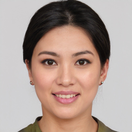 Joyful white young-adult female with medium  black hair and brown eyes