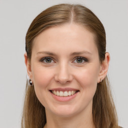 Joyful white young-adult female with long  brown hair and grey eyes