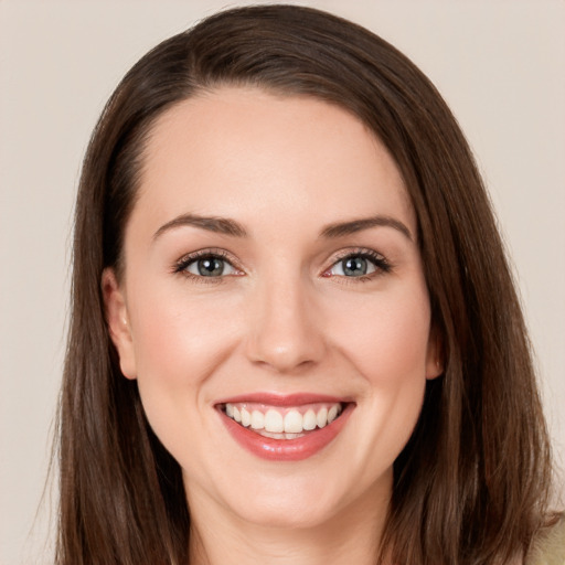 Joyful white young-adult female with long  brown hair and grey eyes