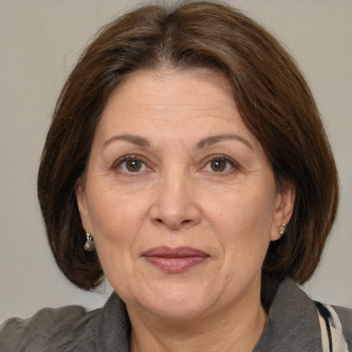 Joyful white middle-aged female with medium  brown hair and brown eyes