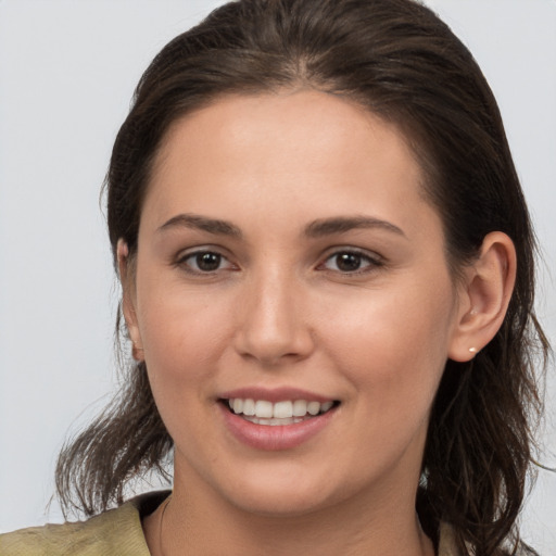 Joyful white young-adult female with medium  brown hair and brown eyes