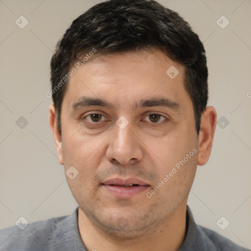 Joyful white adult male with short  black hair and brown eyes