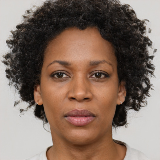 Joyful black adult female with short  brown hair and brown eyes