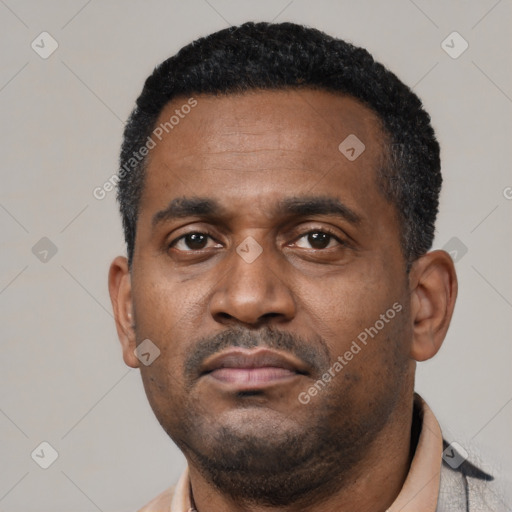 Neutral latino adult male with short  black hair and brown eyes