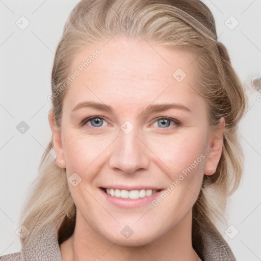 Joyful white young-adult female with long  brown hair and blue eyes