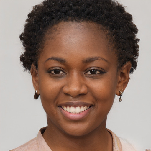 Joyful black young-adult female with short  brown hair and brown eyes