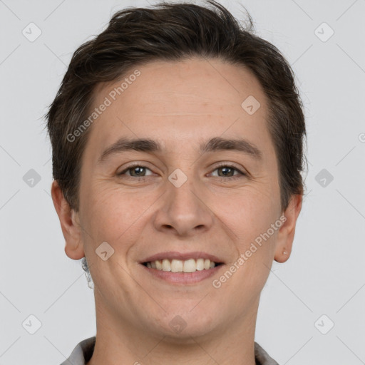 Joyful white adult male with short  brown hair and grey eyes