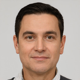 Joyful white adult male with short  brown hair and brown eyes