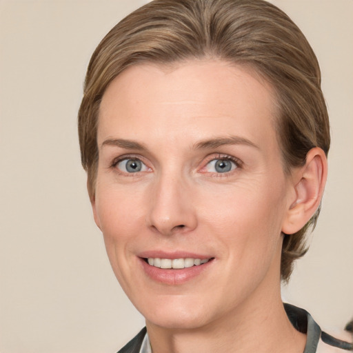 Joyful white adult female with medium  brown hair and grey eyes