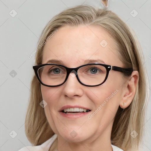 Joyful white adult female with medium  brown hair and blue eyes