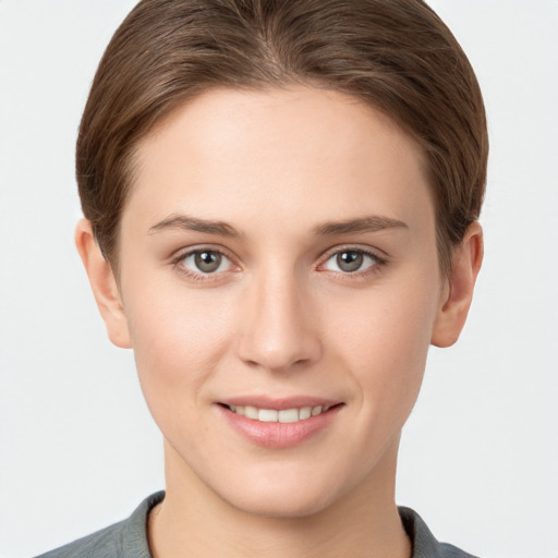 Joyful white young-adult female with short  brown hair and grey eyes