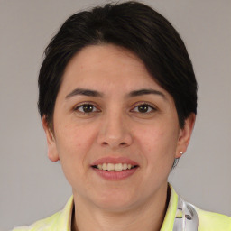 Joyful white young-adult female with medium  brown hair and brown eyes