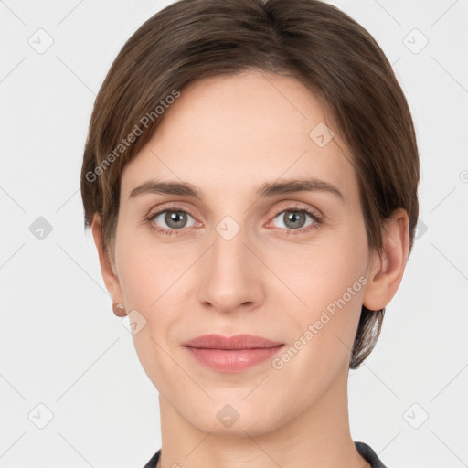 Joyful white young-adult female with short  brown hair and grey eyes