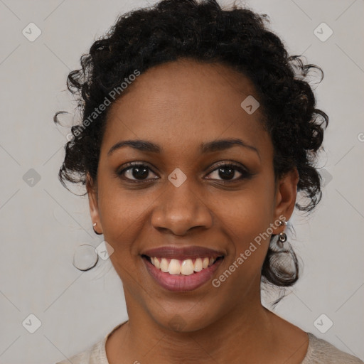 Joyful black young-adult female with medium  black hair and brown eyes