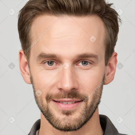 Joyful white young-adult male with short  brown hair and grey eyes