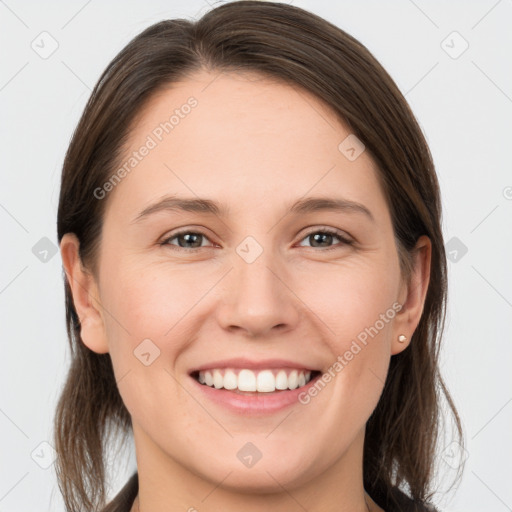 Joyful white young-adult female with long  brown hair and grey eyes