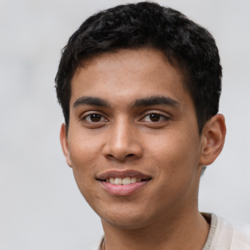 Joyful latino young-adult male with short  brown hair and brown eyes