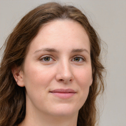 Joyful white young-adult female with long  brown hair and green eyes