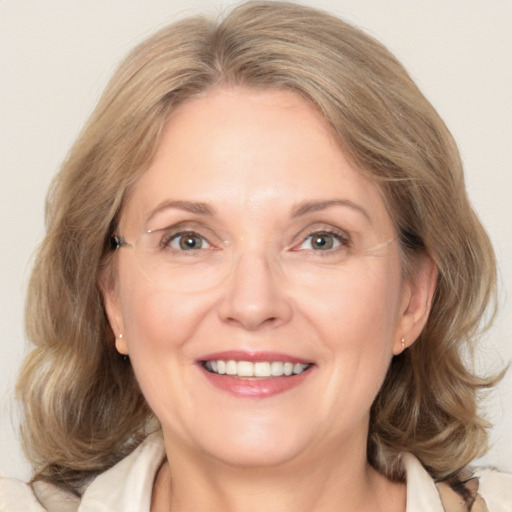 Joyful white adult female with medium  brown hair and grey eyes