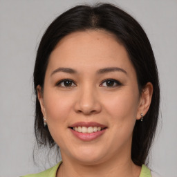 Joyful latino young-adult female with medium  brown hair and brown eyes