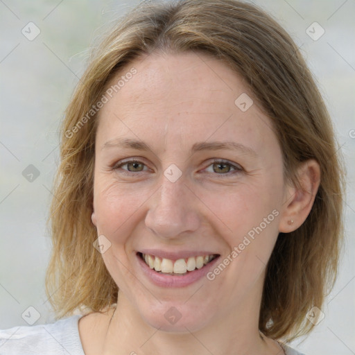 Joyful white adult female with medium  brown hair and blue eyes