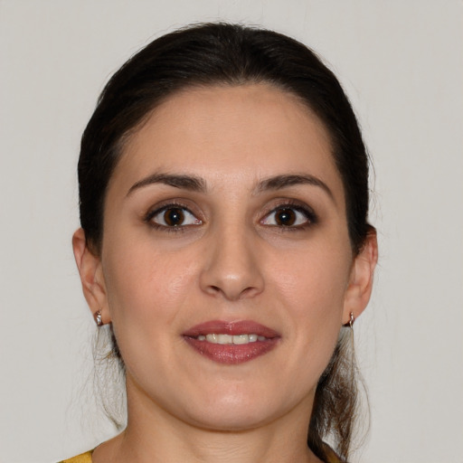 Joyful white young-adult female with medium  brown hair and brown eyes