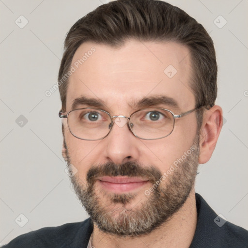 Joyful white adult male with short  brown hair and brown eyes