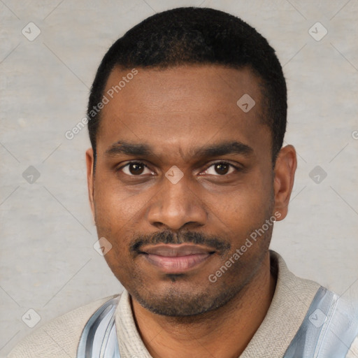 Joyful black young-adult male with short  black hair and brown eyes