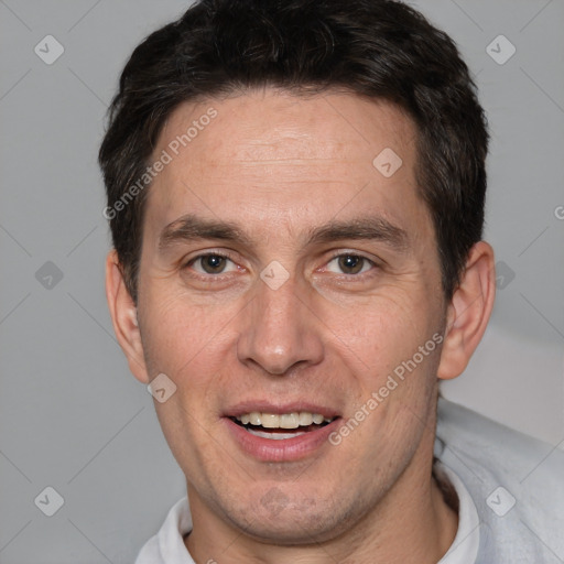 Joyful white adult male with short  brown hair and brown eyes