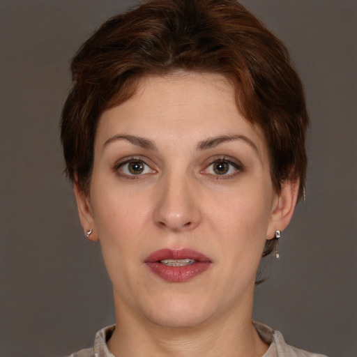 Joyful white adult female with short  brown hair and brown eyes