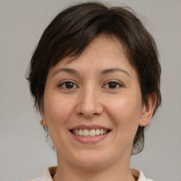 Joyful white adult female with medium  brown hair and brown eyes