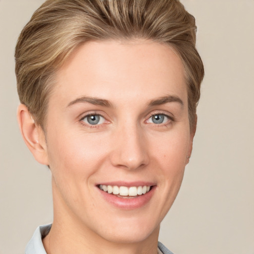 Joyful white young-adult female with short  brown hair and grey eyes