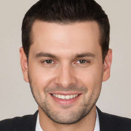 Joyful white young-adult male with short  brown hair and brown eyes