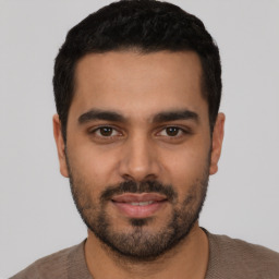 Joyful latino young-adult male with short  black hair and brown eyes