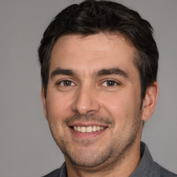 Joyful white adult male with short  brown hair and brown eyes