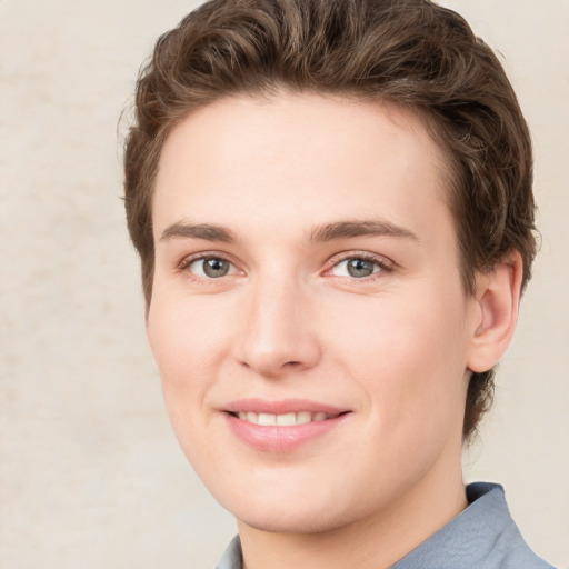 Joyful white young-adult female with short  brown hair and green eyes