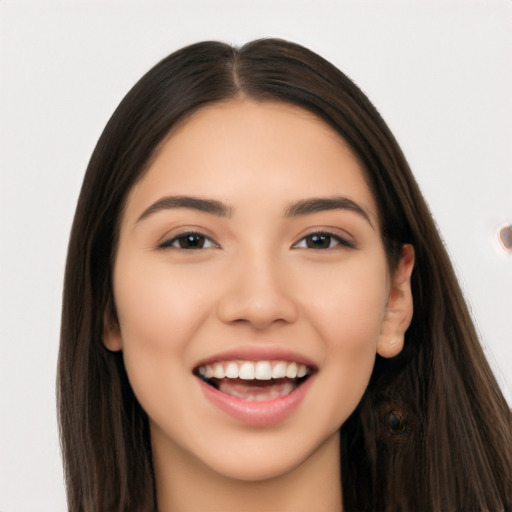 Joyful white young-adult female with long  black hair and brown eyes