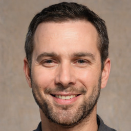 Joyful white adult male with short  brown hair and brown eyes