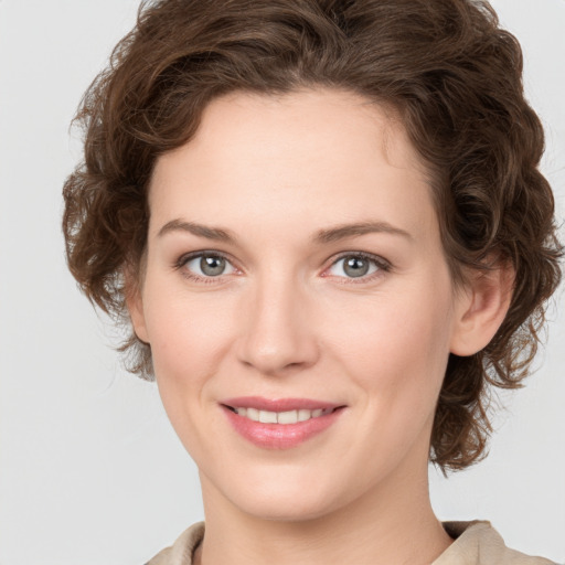 Joyful white young-adult female with medium  brown hair and green eyes