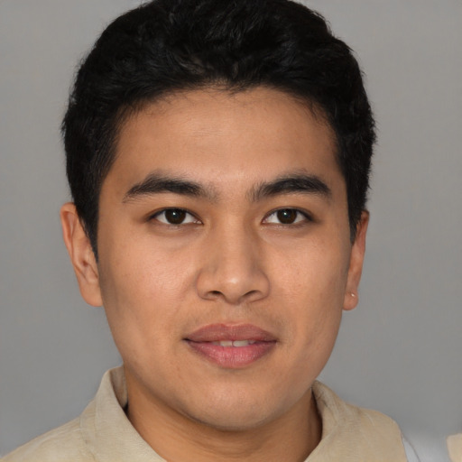 Joyful latino young-adult male with short  brown hair and brown eyes