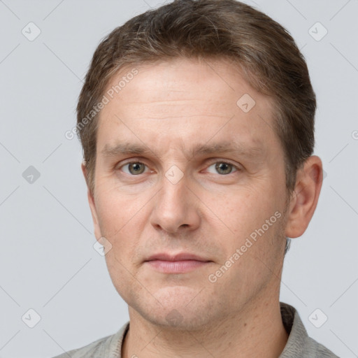 Joyful white adult male with short  brown hair and grey eyes