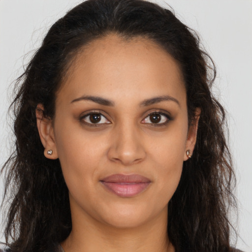 Joyful latino young-adult female with long  brown hair and brown eyes