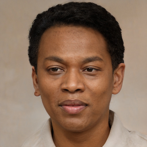 Joyful black young-adult male with short  black hair and brown eyes