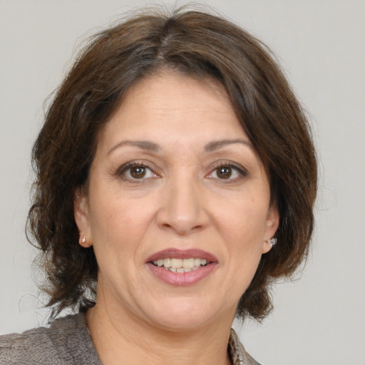 Joyful white adult female with medium  brown hair and brown eyes