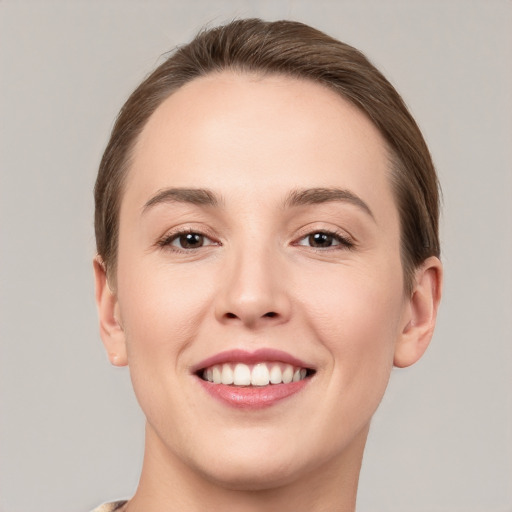 Joyful white young-adult female with short  brown hair and brown eyes