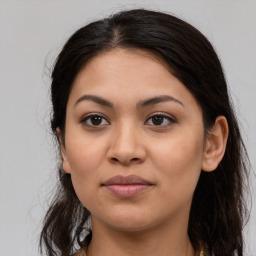 Joyful latino young-adult female with long  brown hair and brown eyes